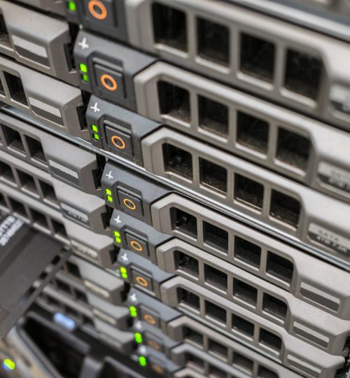 Array of database servers with many hard drives and service tag. Powerful computer equipment works in the server room of the data center. Front panel of the network router. Selective focus